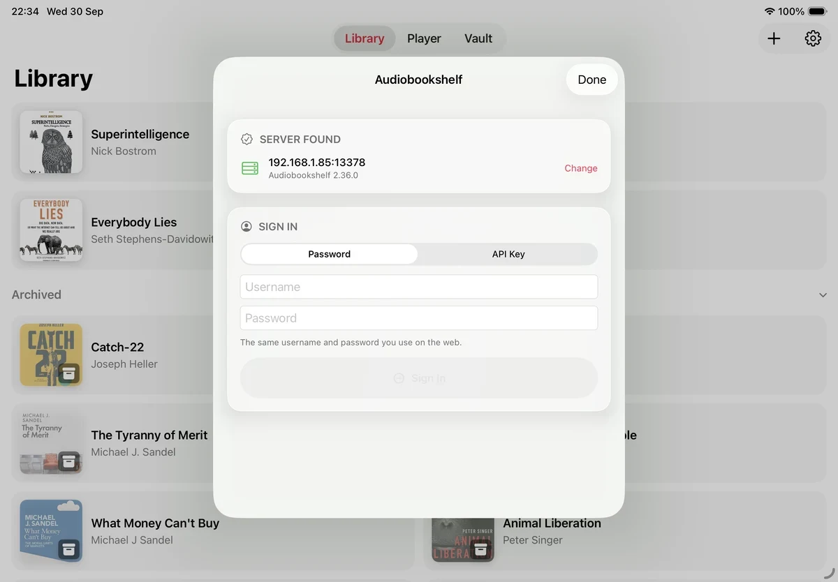 The Audiobookshelf sheet on iPad showing Server Found with the server's address and version, above a Sign In section with Password and API Key tabs.